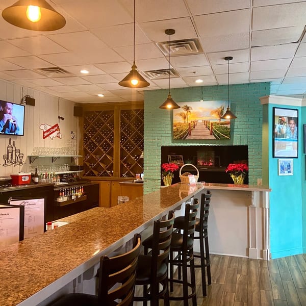 The Irie Diner bar area features a long counter with stools, wine rack, and Caribbean-themed decor.