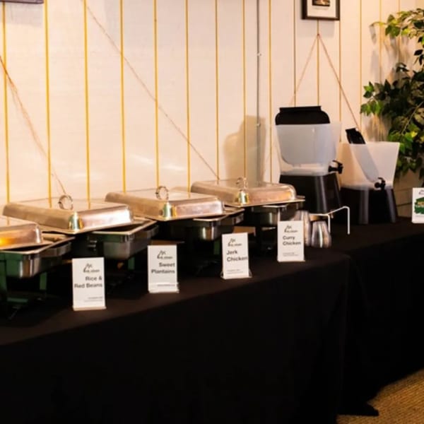 Irie Diner's Jamaican buffet with chafing dishes of rice, plantains, jerk chicken, and curry chicken.